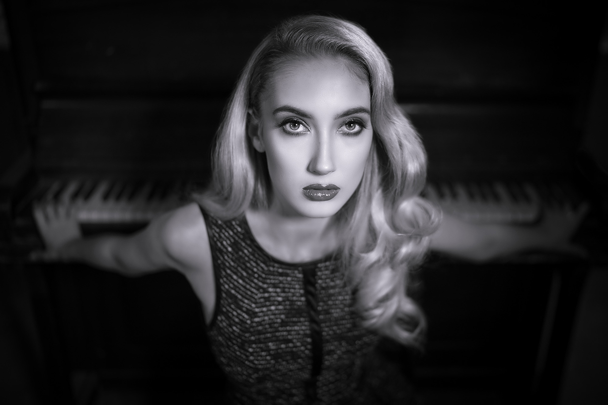 terry-donnelly-sony-alpha-9-portrait-of-a-lady-leaning-against-a-piano-keyboard.jpg